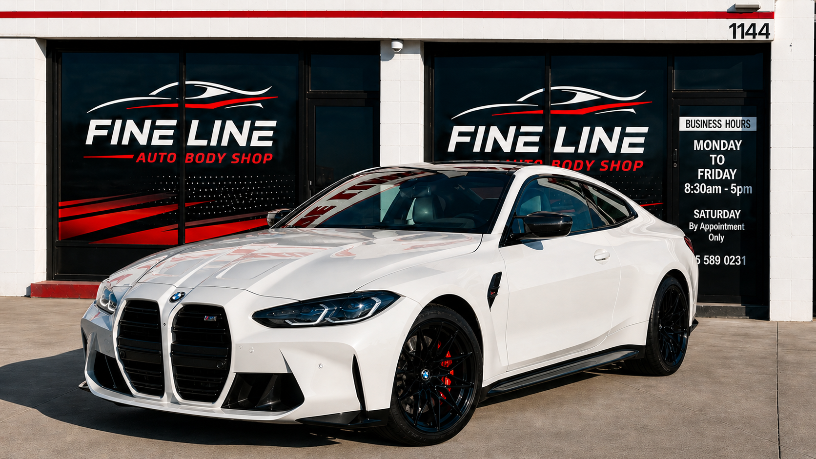 White BMW sports car in front of Fine Line Auto Body Shop